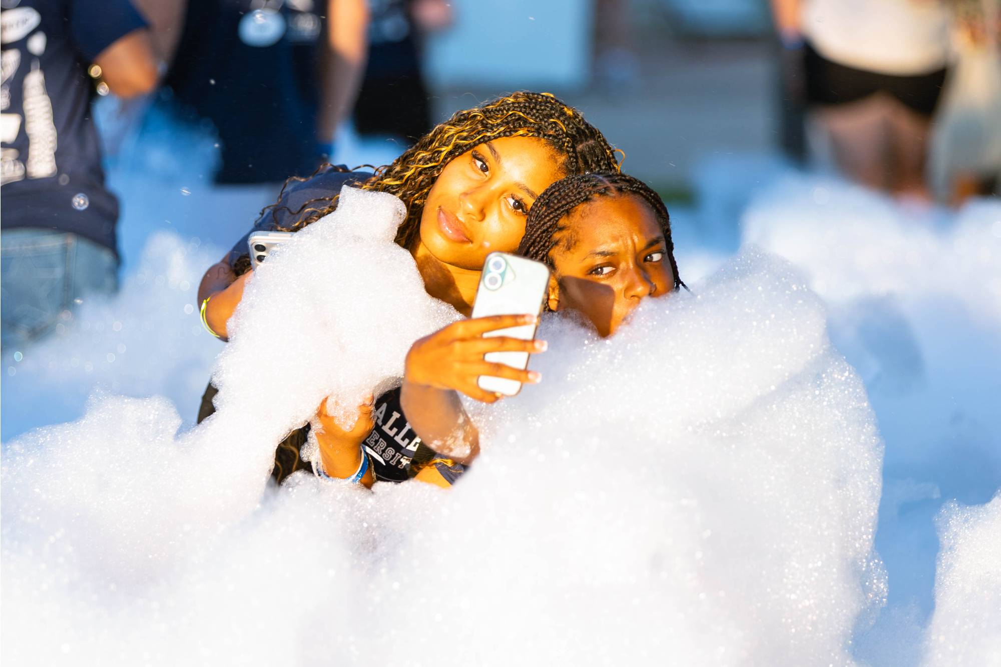 Two Girls Taking a Photo in the Foam